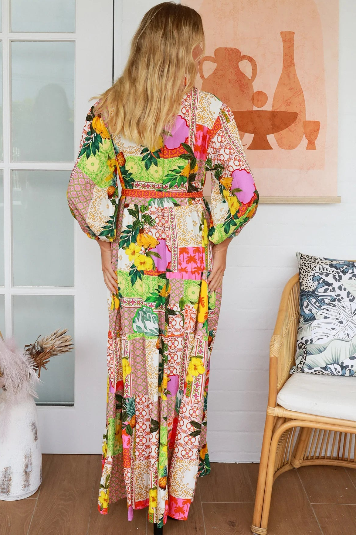 “Woman in tropical patchwork bamboo rayon boho maxi dress with red collar and tie belt — sustainable bohemian fashion Australia.”