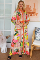 “Woman in tropical patchwork bamboo rayon boho maxi dress with red collar and tie belt — sustainable bohemian fashion Australia.”