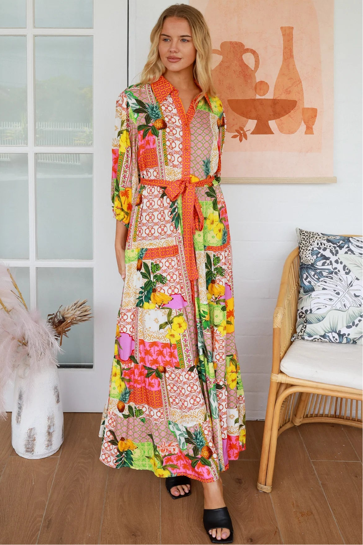 “Woman in tropical patchwork bamboo rayon boho maxi dress with red collar and tie belt — sustainable bohemian fashion Australia.”