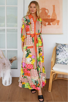 “Woman in tropical patchwork bamboo rayon boho maxi dress with red collar and tie belt — sustainable bohemian fashion Australia.”