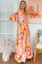Jacqueline Floral Maxi Dress by Salty Palm in coral pink patchwork floral print with sash, pockets and button-through front
