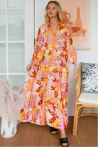 Jacqueline Floral Maxi Dress by Salty Palm in coral pink patchwork floral print with sash, pockets and button-through front