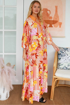 Jacqueline Floral Maxi Dress by Salty Palm in coral pink patchwork floral print with sash, pockets and button-through front
