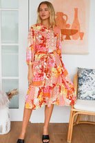 Jacqueline Floral Midi Dress by Salty Palm in coral pink patchwork floral print with split neckline and self-tie sash