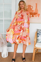 Jacqueline Floral Midi Dress by Salty Palm in coral pink patchwork floral print with split neckline and self-tie sash
