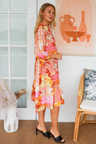 Jacqueline Floral Midi Dress by Salty Palm in coral pink patchwork floral print with split neckline and self-tie sash