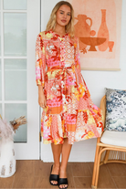 Jacqueline Floral Midi Dress by Salty Palm in coral pink patchwork floral print with split neckline and self-tie sash