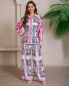 Model wearing pink floral baroque print shirt and wide-leg pants set with long sleeve and contrast piping - boho two-piece outfit Australia.