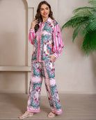 Model wearing pink floral baroque print shirt and wide-leg pants set with long sleeve and contrast piping - boho two-piece outfit Australia.
