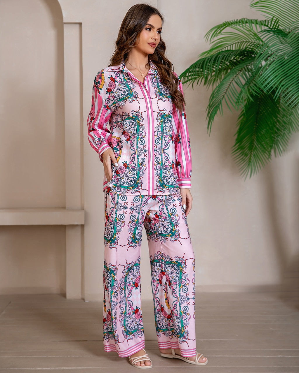 Model wearing pink floral baroque print shirt and wide-leg pants set with long sleeve and contrast piping - boho two-piece outfit Australia.