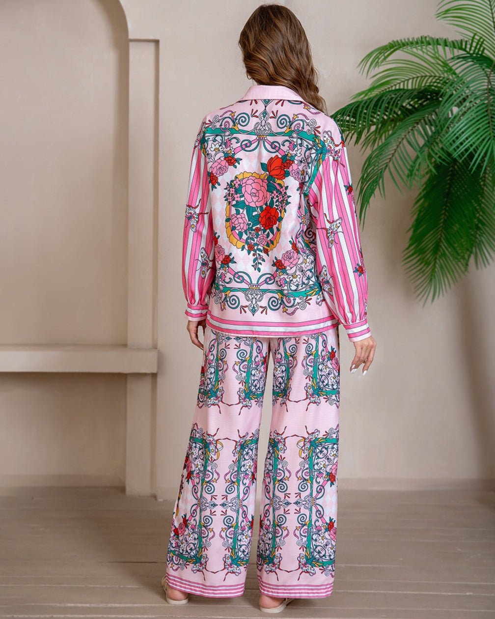 Model wearing pink floral baroque print shirt and wide-leg pants set with long sleeve and contrast piping - boho two-piece outfit Australia.