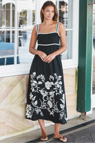 Black and white floral rayon maxi dress with tie-back detail against a black base styled for Australian boho fashion