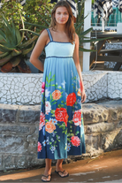 Woman wearing a teal floral boho maxi dress with tie-back detail, elasticated back and pockets – Australian bohemian fashion
