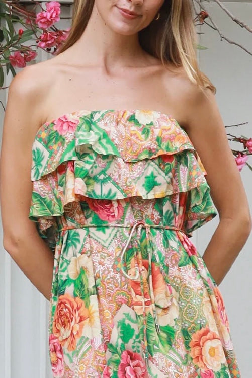 Model wearing a Dreamcatcher Raya strapless floral patchwork maxi dress in green and pink with ruffle bodice and tiered skirt