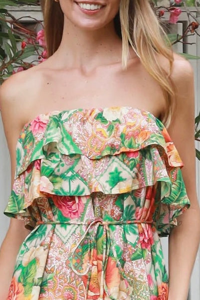 Model wearing a Dreamcatcher Raya strapless floral patchwork maxi dress in green and pink with ruffle bodice and tiered skirt