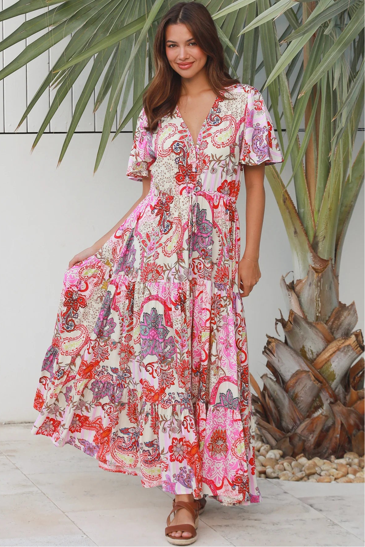 Pink paisley bohemian maxi dress with flutter sleeves, drawstring waist and tiered hem in softly draped rayon. Boho Dresses Australia.