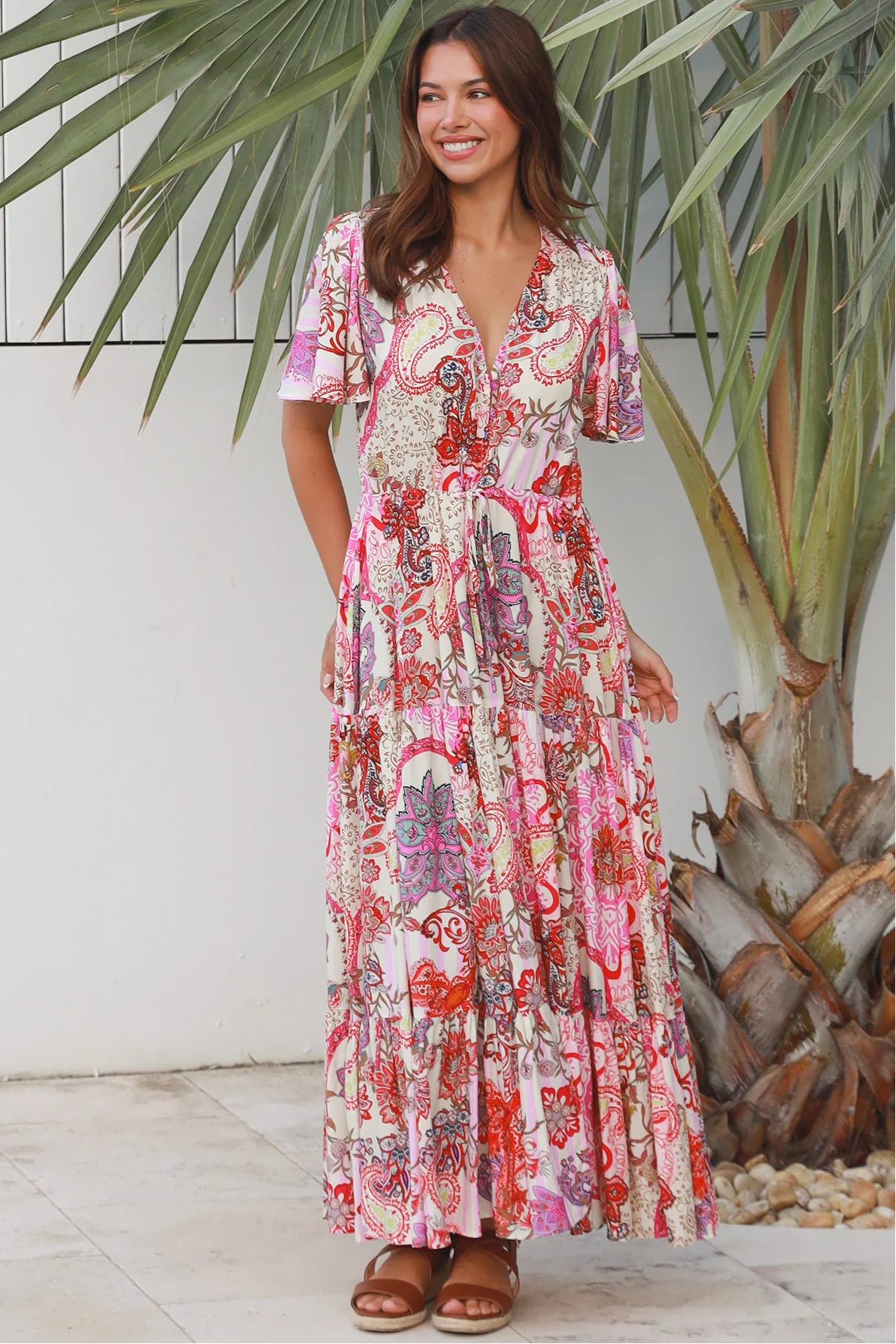 Pink paisley bohemian maxi dress with flutter sleeves, drawstring waist and tiered hem in softly draped rayon. Boho Dresses Australia.