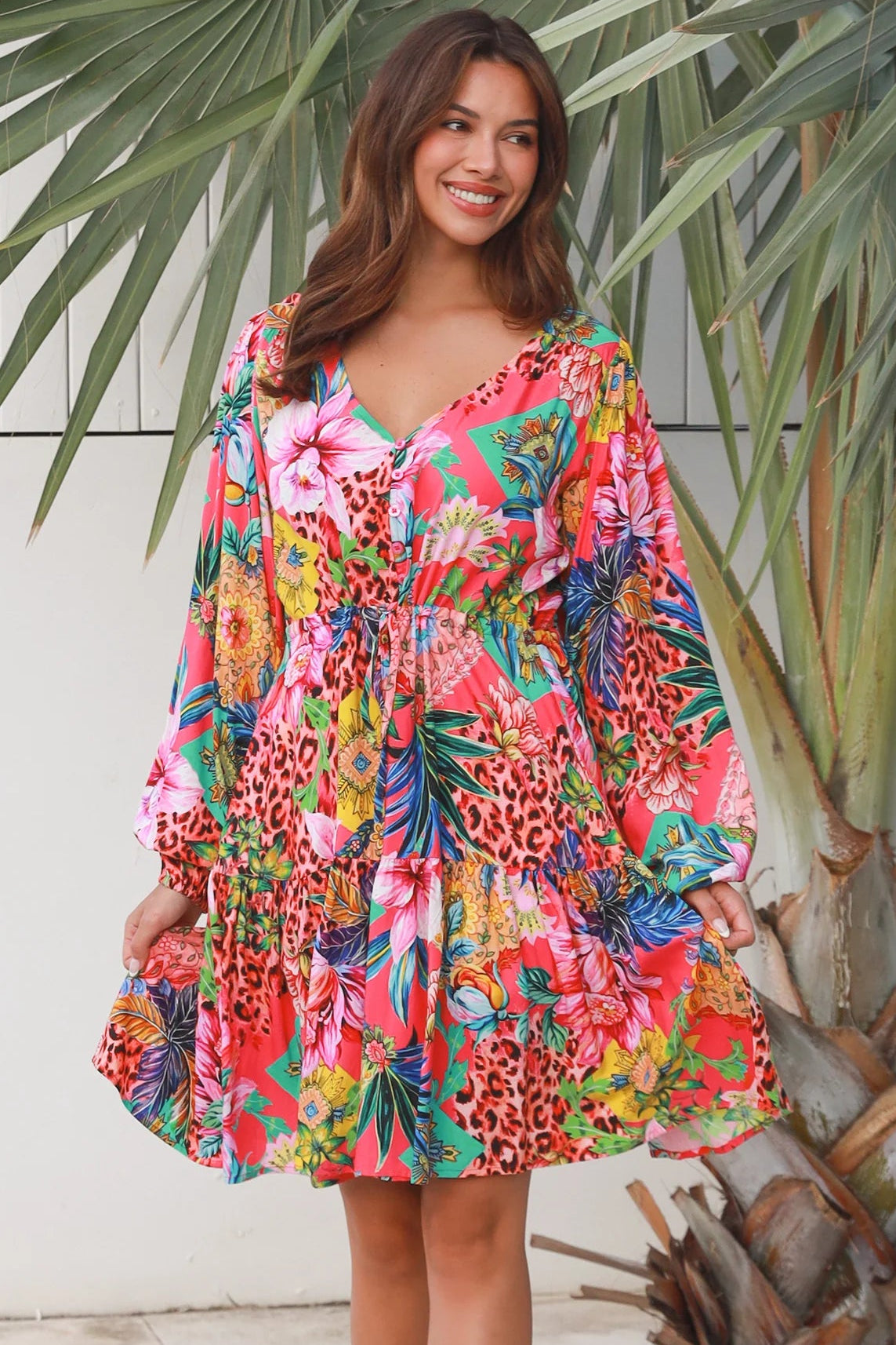 Woman wearing a jungle floral rayon above knee mini dress with blouson sleeves by Dreamcatcher in Australia