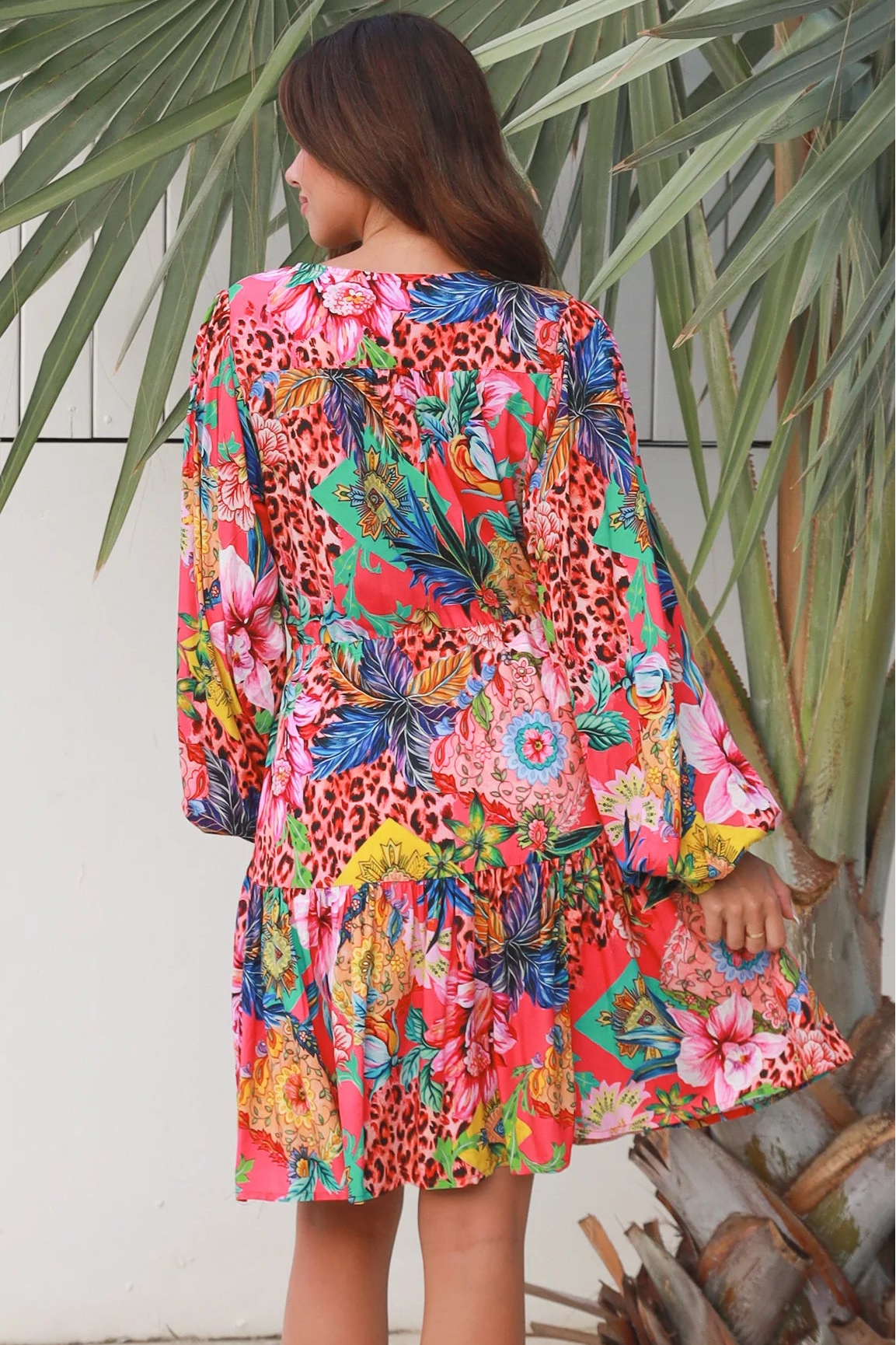 Woman wearing a jungle floral rayon above knee mini dress with blouson sleeves by Dreamcatcher in Australia