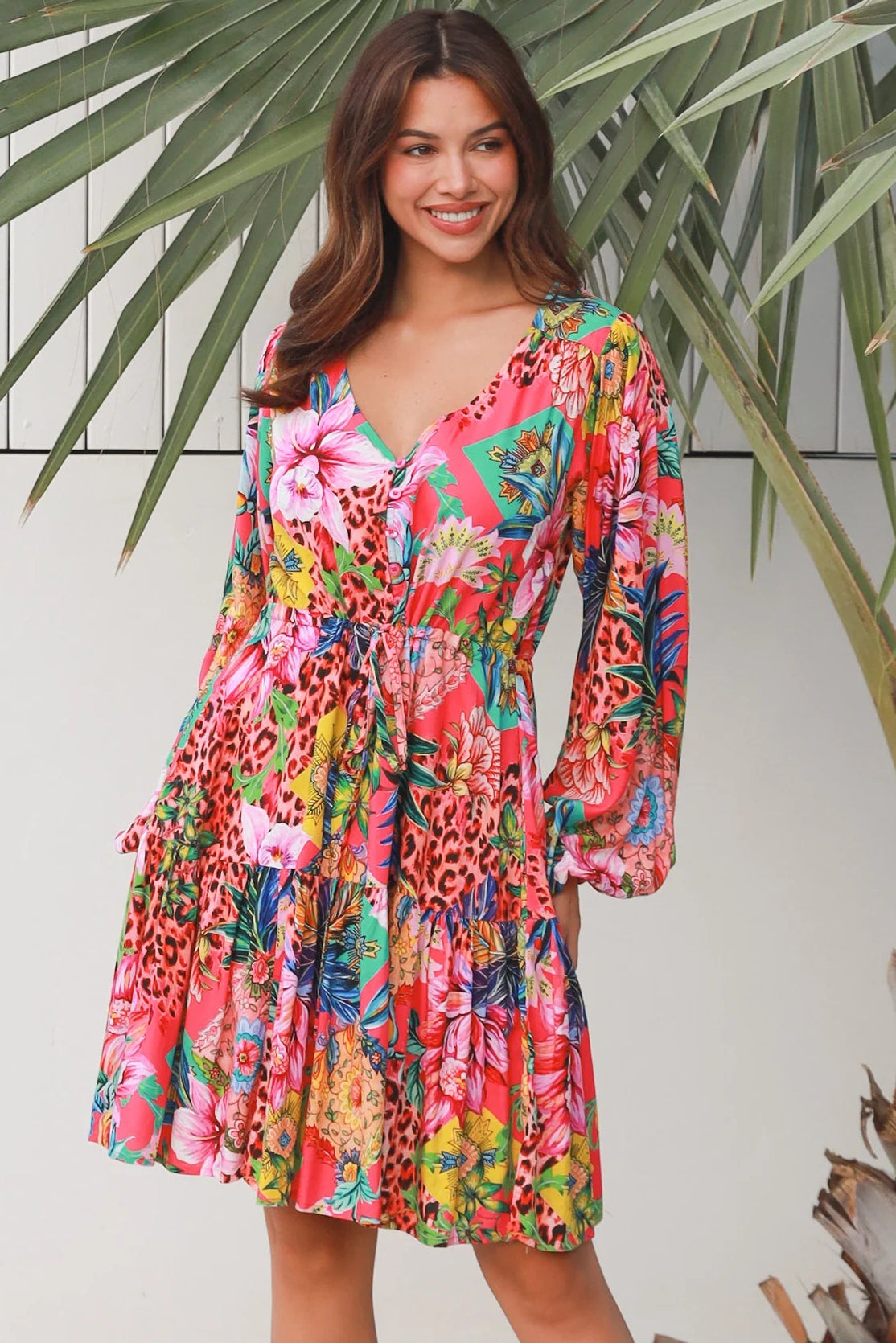 Woman wearing a jungle floral rayon above knee mini dress with blouson sleeves by Dreamcatcher in Australia