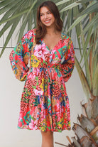 Woman wearing a jungle floral rayon above knee mini dress with blouson sleeves by Dreamcatcher in Australia