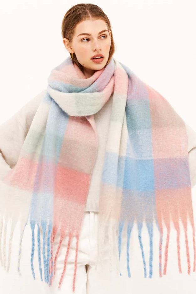 Woman in a pastel check boho winter scarf with blush, blue, and cream tones and long tassels - The Aurielle Scarf by Bohemian Love Runway 