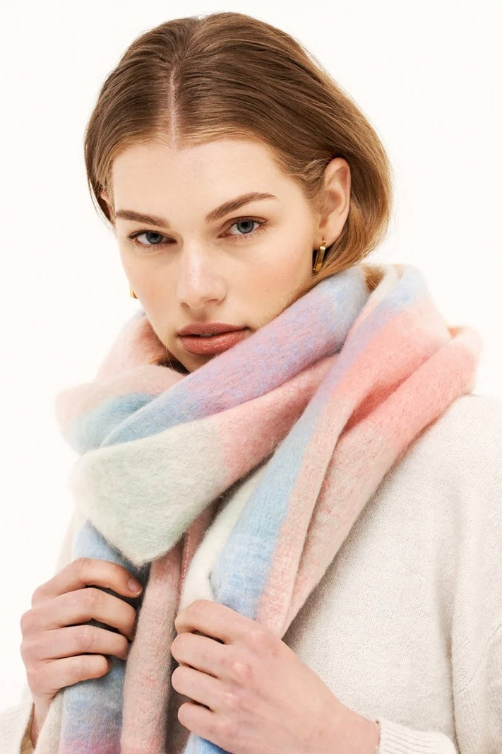 Woman in a pastel check boho winter scarf with blush, blue, and cream tones and long tassels - The Aurielle Scarf by Bohemian Love Runway 
