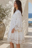 Model wearing the Honeyed Garden white cotton embroidered mini dress with floral cutwork hem and sleeves at Bohemian Love Runway