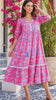 Model in motion wearing the Mahale Sanctuary Midi Dress Pluto Pink in 100% cotton with turquoise wildlife print, white lace trim and frill hem | Bohemian Love Runway