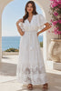 Model in motion wearing the Willow white embroidered cotton maxi dress with openwork lace and tassel ties by Salty Palm at Bohemian Love Runway