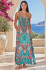 Model in motion wearing the Mirage aqua blue rhinestone maxi dress in viscose crepe with vivid floral placement print and flowing skirt | Bohemian Love Runway