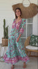 Woman twirling in the Morning Meadows Boho Maxi Dress in turquoise green with floral print - bohemian fashion Australia