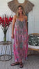 Woman in rose floral boho kimono and rhinestone midi dress twirling in sunlight – resort luxe Peacock Feather collection