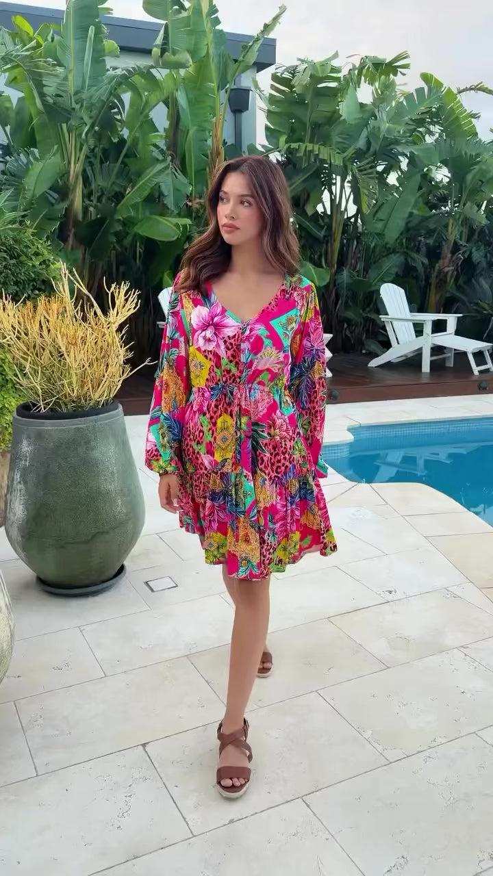 Woman wearing a jungle floral rayon above knee mini dress with blouson sleeves by Dreamcatcher in Australia