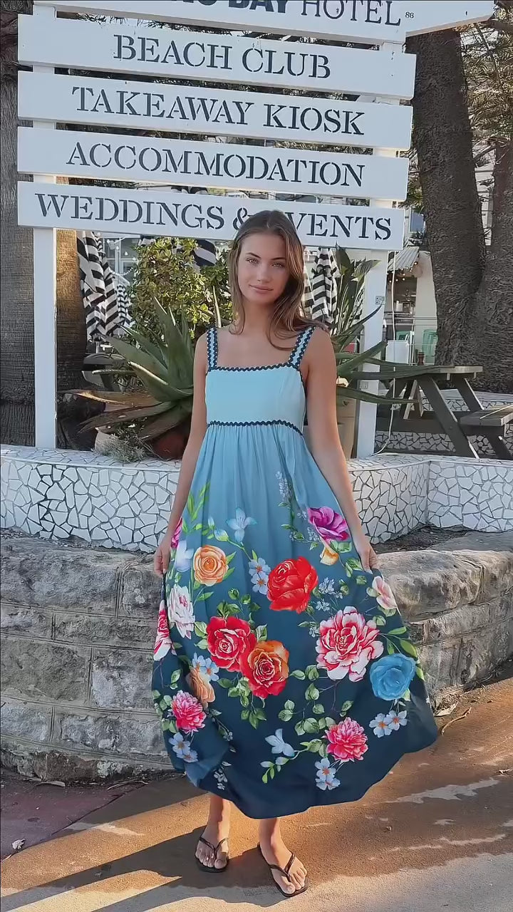 Woman wearing a teal floral boho maxi dress with tie-back detail, elasticated back and pockets – Australian bohemian fashion