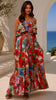 Model wearing the Scarlet floral strapless maxi dress by Dreamcatcher with double frill, waist tie and oversized frill hem