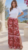 Model in motion wearing the Claudette floral boho maxi skirt in ruby red, blush pink and ivory with border print, elastic waist and side splits at Bohemian Love Runway.