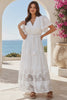 Model in motion wearing the Willow white embroidered cotton maxi dress with openwork lace and tassel ties by Salty Palm at Bohemian Love Runway