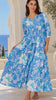 Model in motion wearing the Emerson Cotton Maxi Dress Rory Blue with vintage blue floral print, button front, tassel drawstring waist and tiered skirt | Bohemian Love Runway