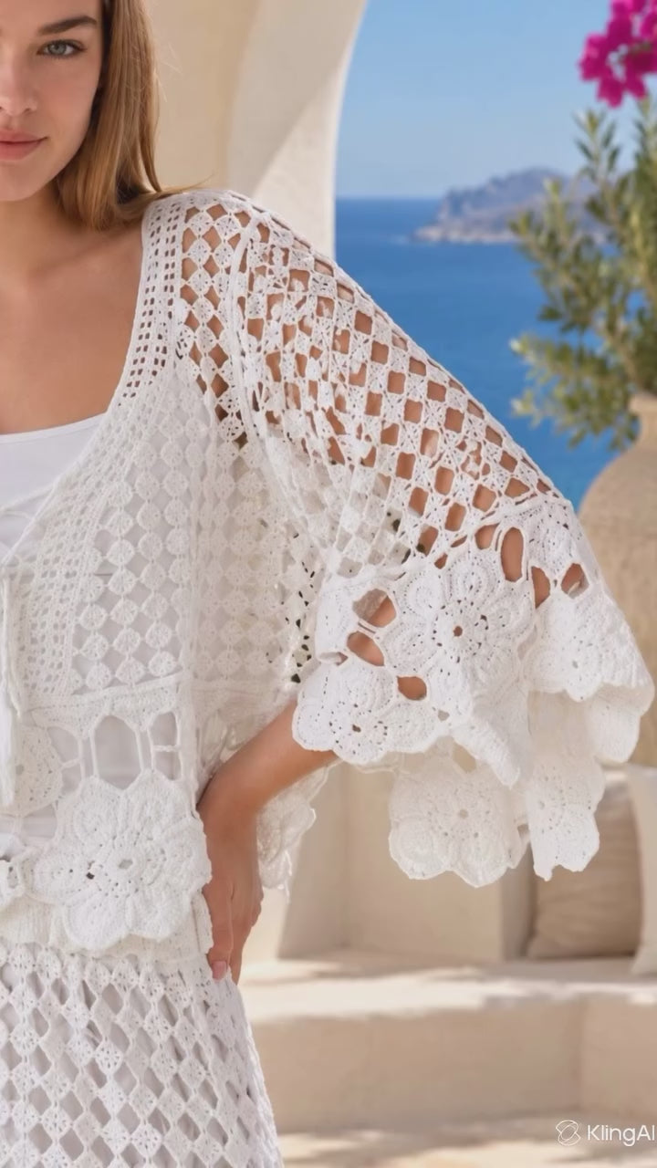 Model in motion wearing the Sienna white crochet two-piece set by Willow the Label with floral crochet top and matching maxi skirt