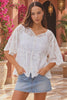 Model in motion wearing the Giselle white boho embroidered cotton top by Willow the Label with scalloped V-neckline, floral embroidery and half sleeves | Bohemian Love Runway 