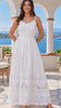 Model in motion wearing the Lola white embroidered cotton maxi dress by Salty Palm featuring floral cutwork, adjustable straps, fitted waist and scalloped lace hem | Bohemian Love Runway
