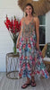 “Woman twirling in a white boho midi dress with rhinestone detailing and tropical floral print — Wanderlust in Bloom Midi Dress by Peacock Feather, Bohemian Love Runway.”