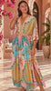 Model in motion wearing the Amara pink turquoise floral paisley maxi dress by Dream Catcher with V-neck, kimono sleeves and border print | Bohemian Love Runway