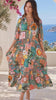 Model in motion wearing the Amira Island Dream tropical patchwork rayon midi dress with V-neck, billowed sleeves and tiered skirt from Bohemian Love Runway.