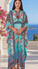 Model in motion wearing the Mirage Floral Kaftan Turquoise Bloom by Peacock Feather the Label in viscose crepe with botanical boho print | Bohemian Love Runway 
