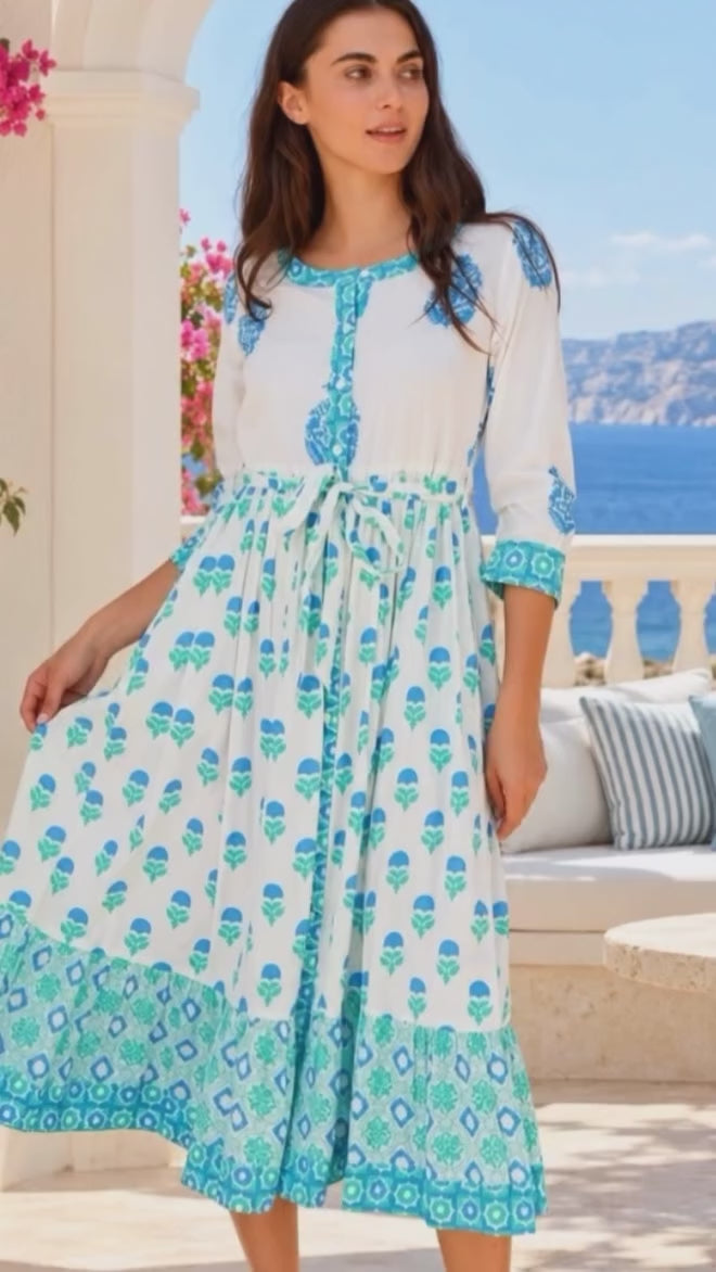 Model in motion wearing the Lovebird Cotton Midi Dress Blue by Peacock Feather, white cotton boho midi dress with blue floral and border prints | Bohemian Love Runway
