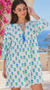 Model in motion wearing the Lovebird blue cotton boho mini dress with green floral block print, tassel V-neckline and gathered empire waist | Bohemian Love Runway
